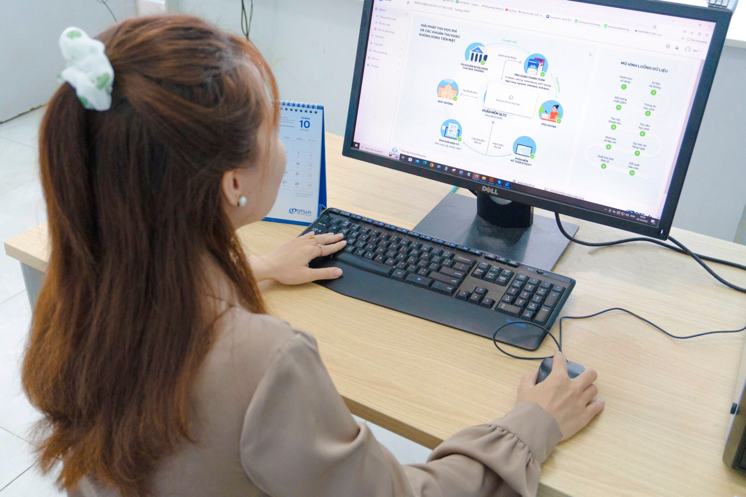 Woman sits at her desk integrating payroll systems